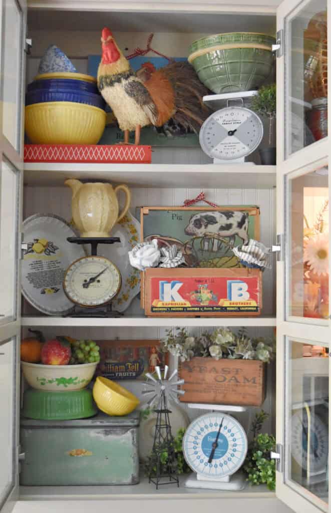 Vintage kitchen finds decorated in kitchen cupboard.