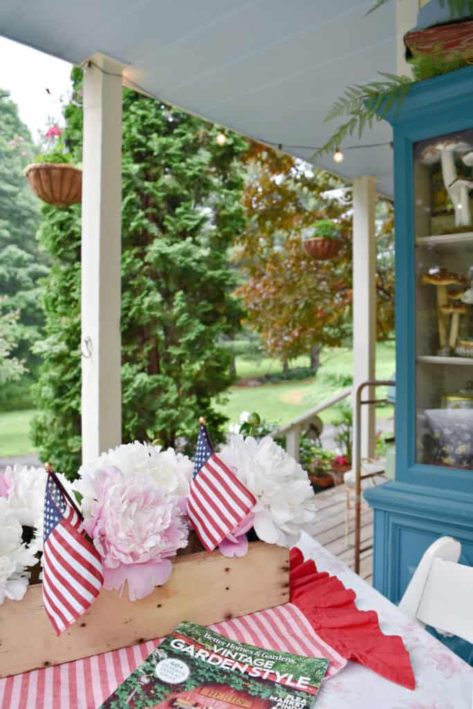 View of backyard from porch table with peony centerpiece.