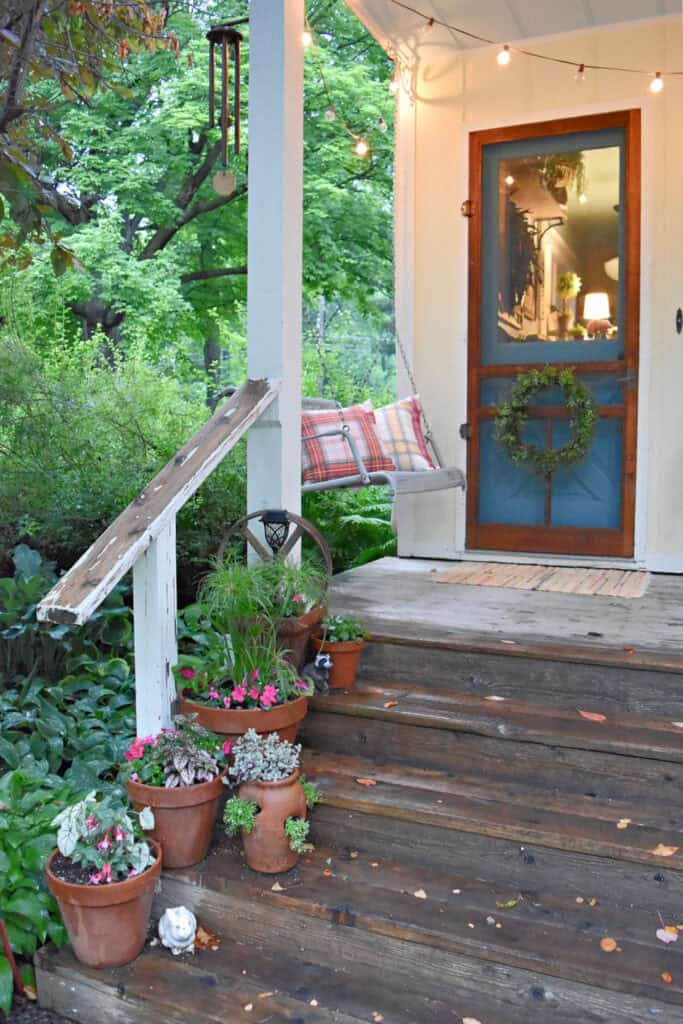 Back screen door on farmhouse porch.