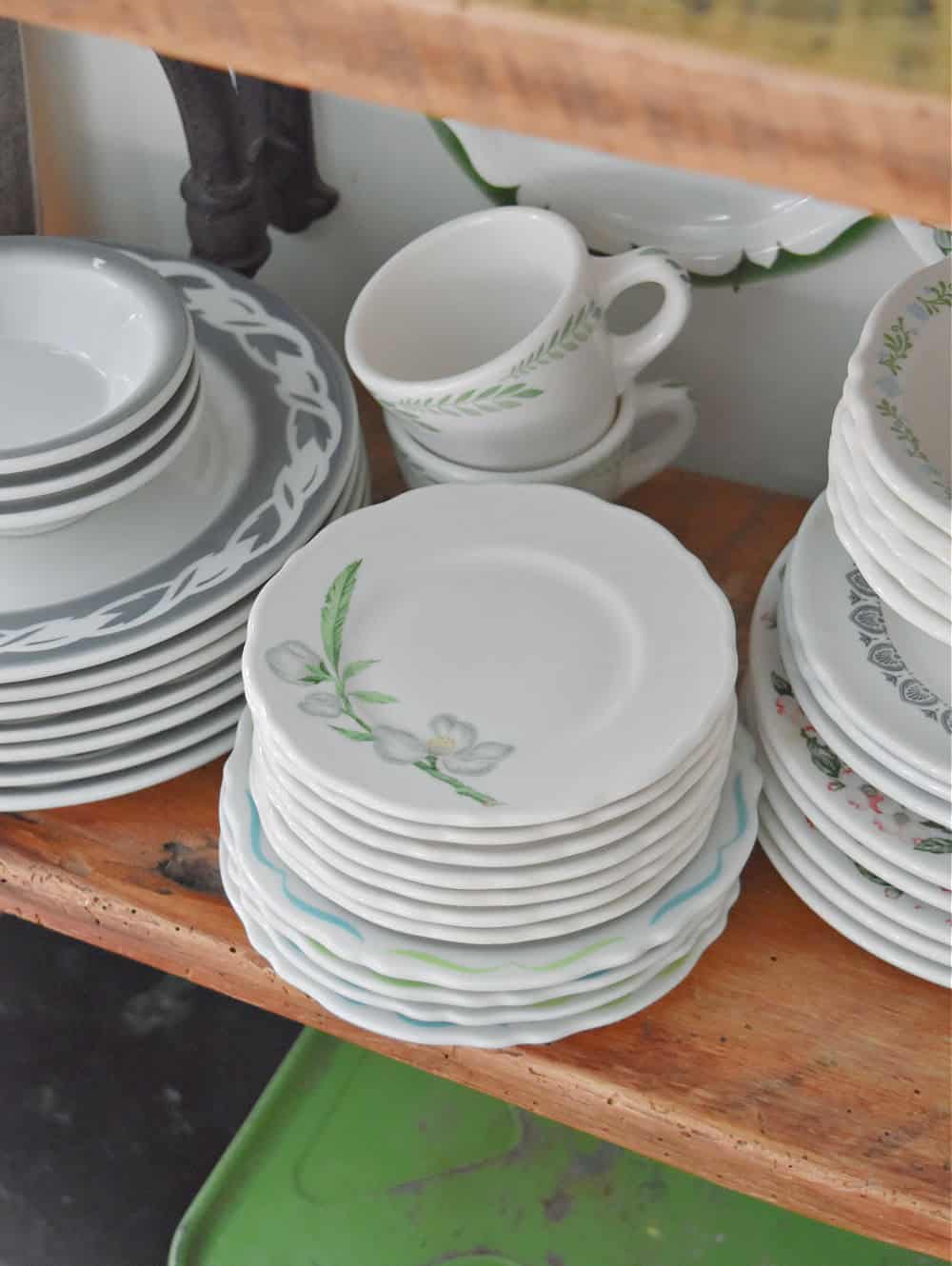Vintage hotel ware dishes on shelf.