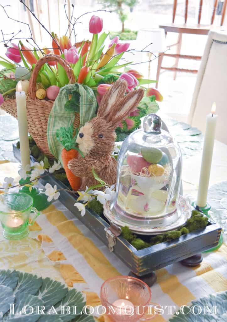 Easter centerpiece with tulips, bunny, and cloche.