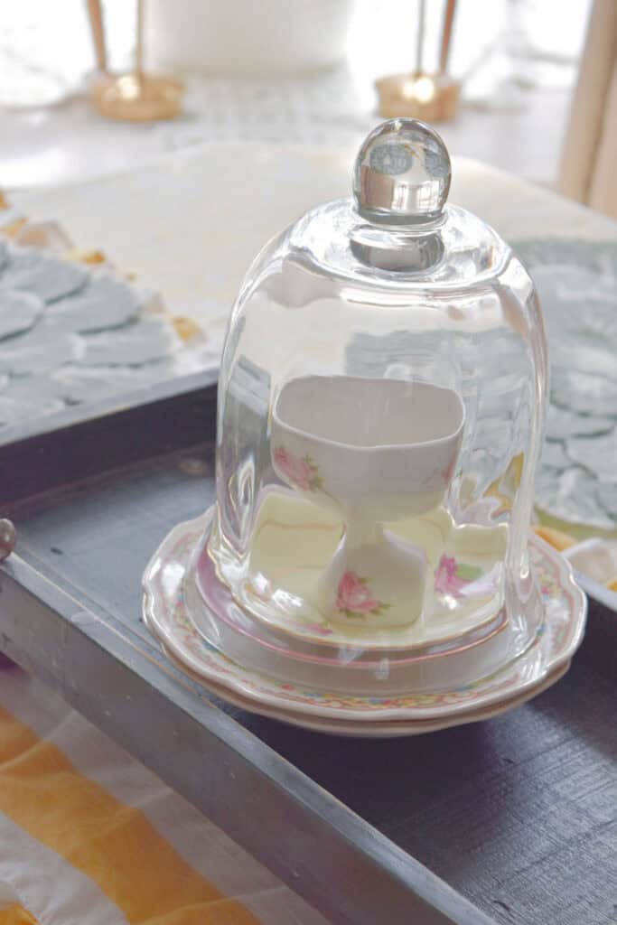 Glass cloche with vintage floral plates.