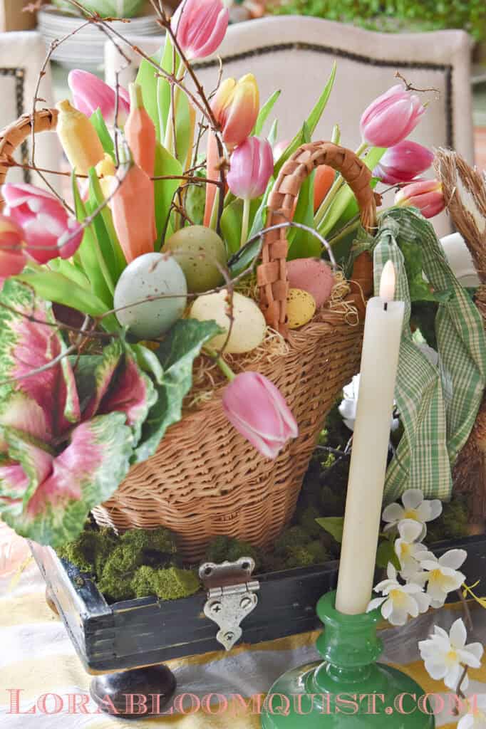 Easter floral arrangement with tulips, carrots and eggs.