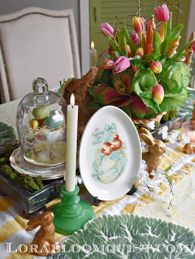 Easter centerpiece with tulips, cloche and bunnies.