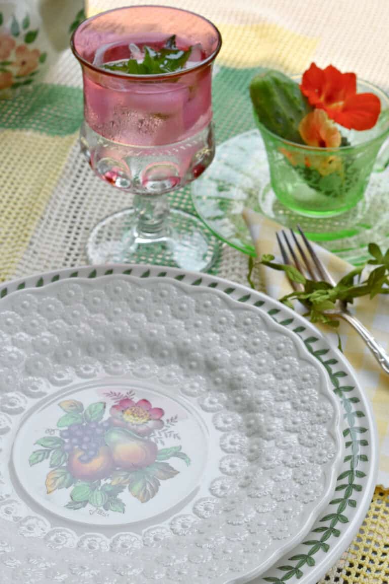 Vintage thrifted dishes on summer table setting.