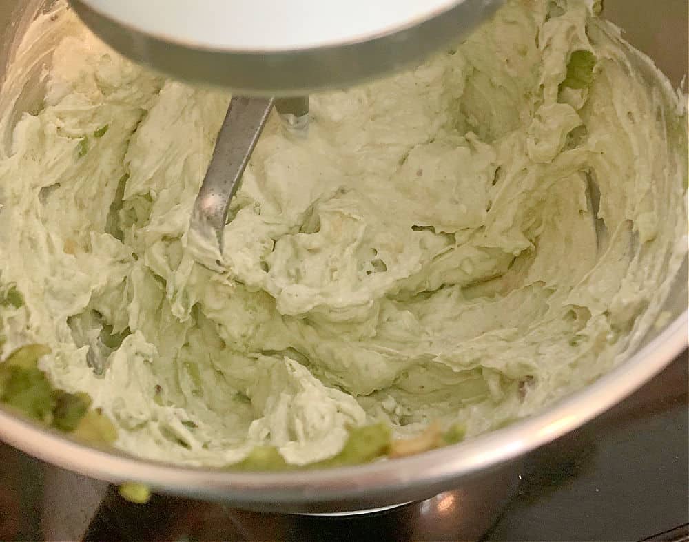 Mixing avocados and cream cheese for dip.