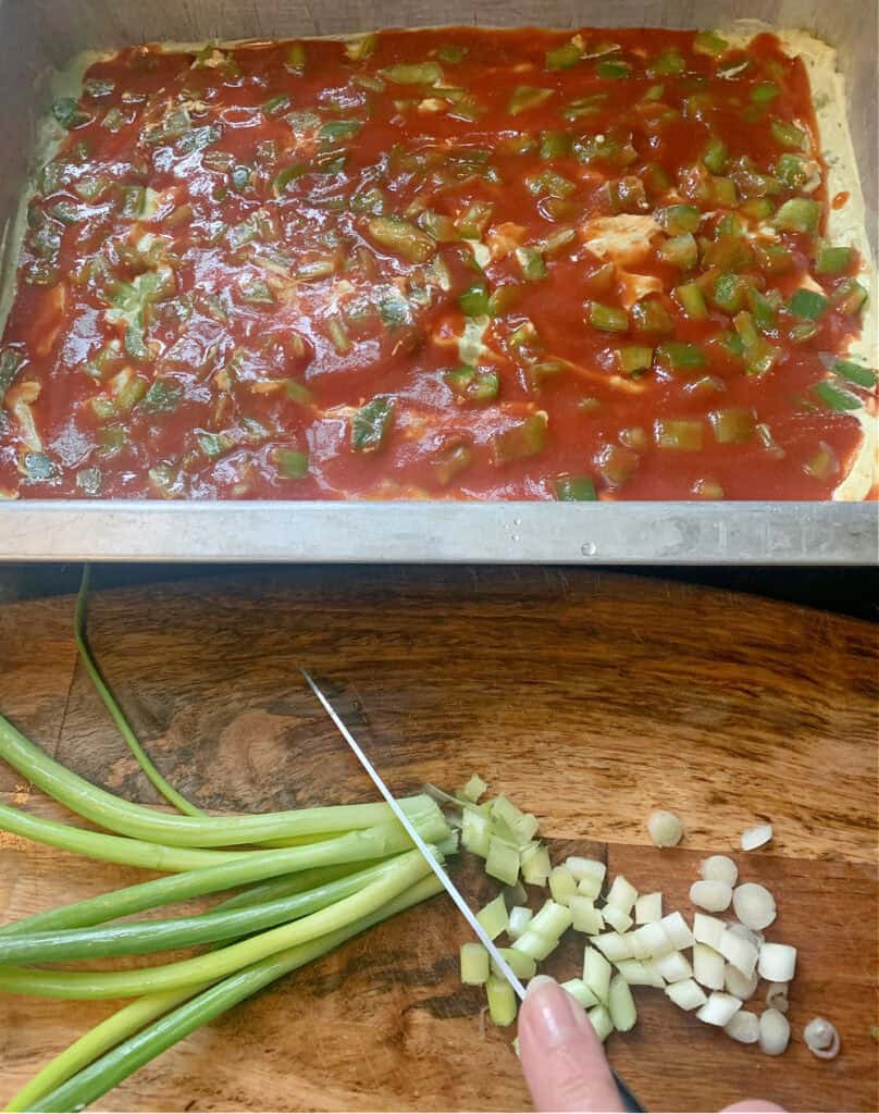 Layering taco sauce on taco dip for a crowd.