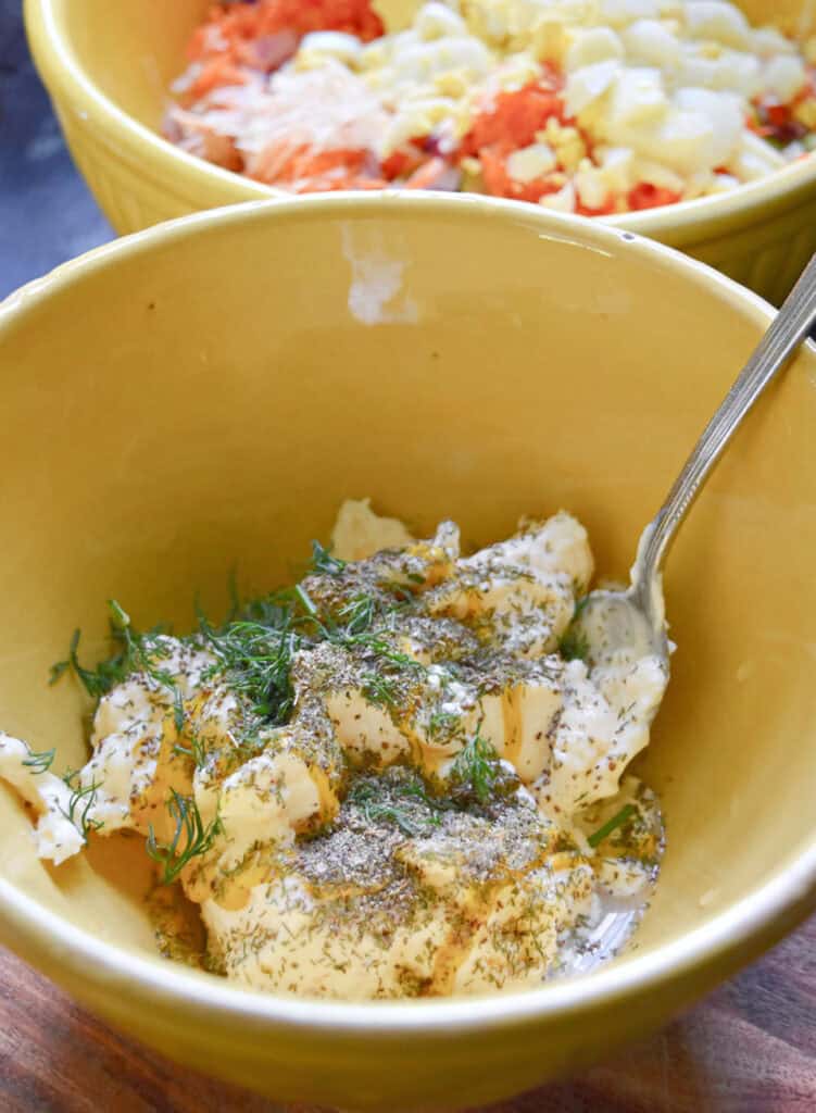 Making salad dressing in yellow bowl.
