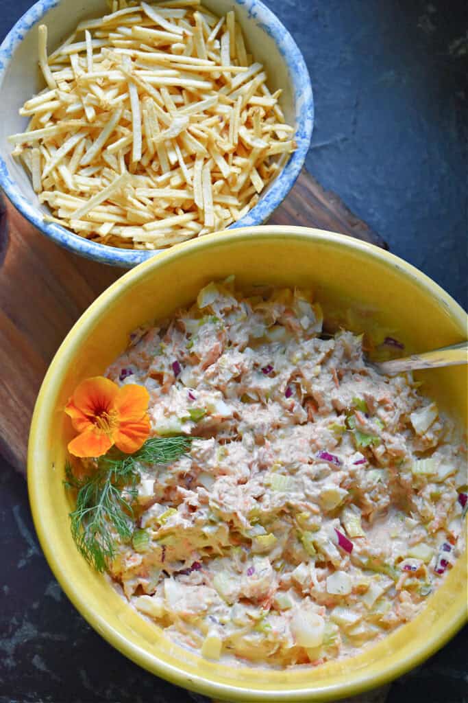 Tuna shoestring salad in yellow bowl.