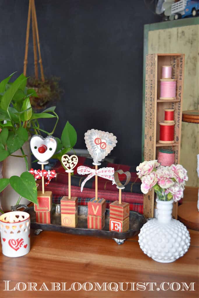 Vintage cookie cutters upcycled with old wooden alphabet blocks as DIY Valentines Decorations.