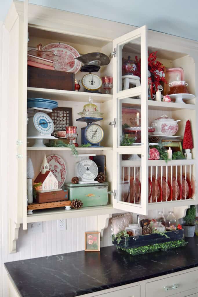 Vintage kitchen decor display in glass cupboards.