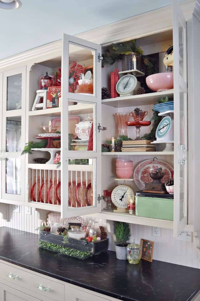 Vintage kitchen decor display in glass cupboards.