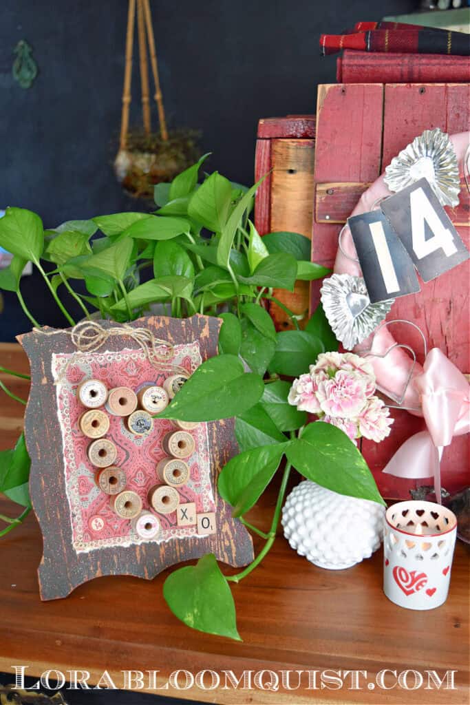 Upcycled vintage valentines decoration with old wooden spools.