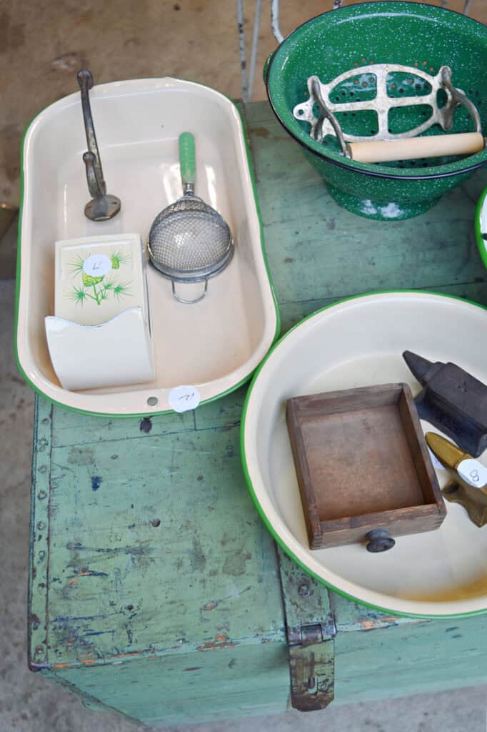 Vintage green and tan enamelware colanders and bowls with vintage estate sale finds.