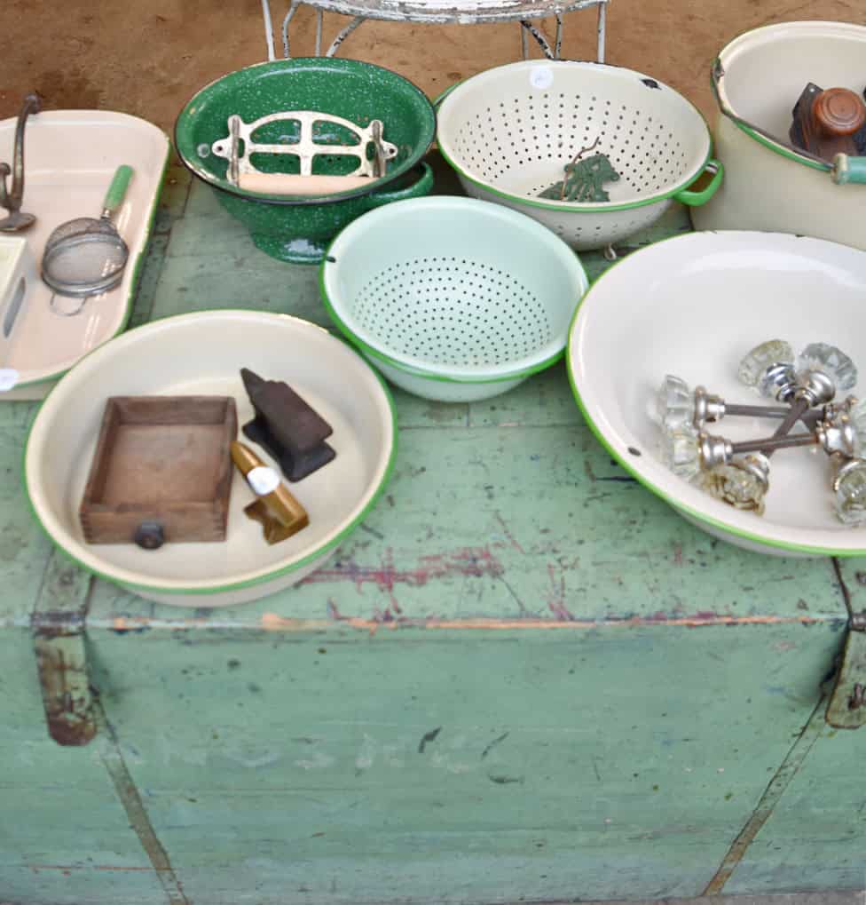 Vintage green and tan enamelware colanders and bowls with vintage estate sale finds.