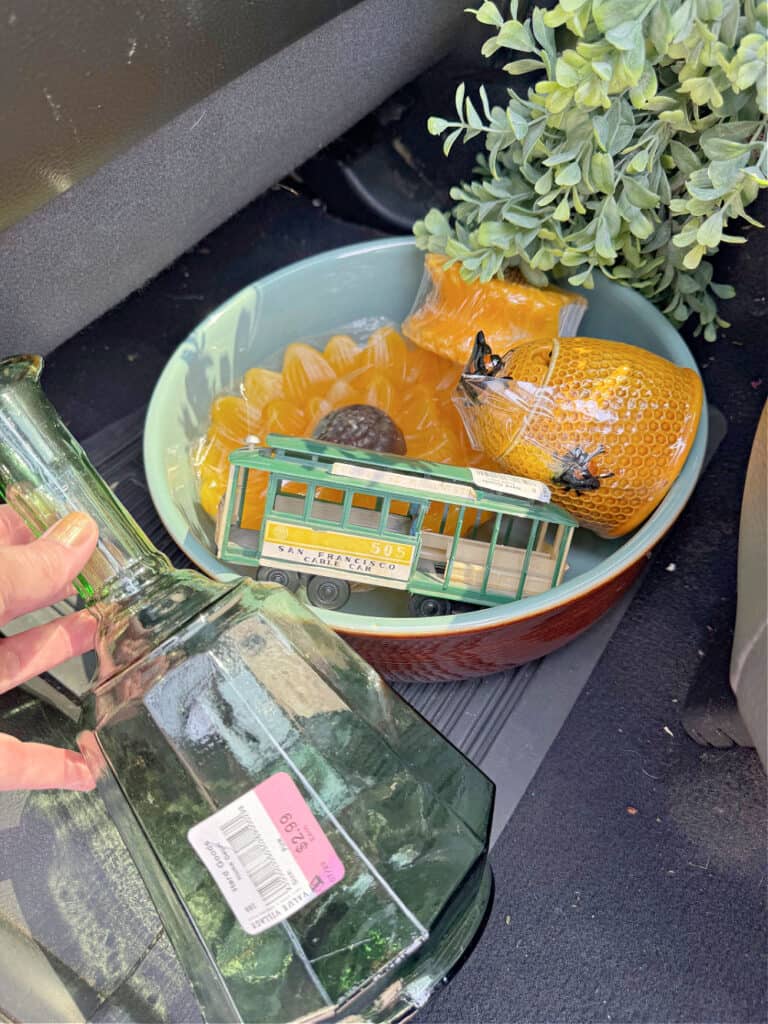 Thrifted finds: green glass bottle, sunflower candles and childs trolly.