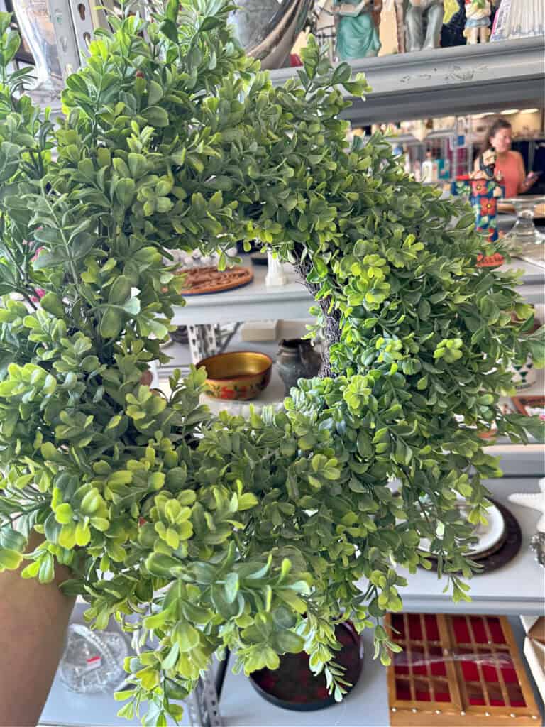 Faux green boxwood wreath.