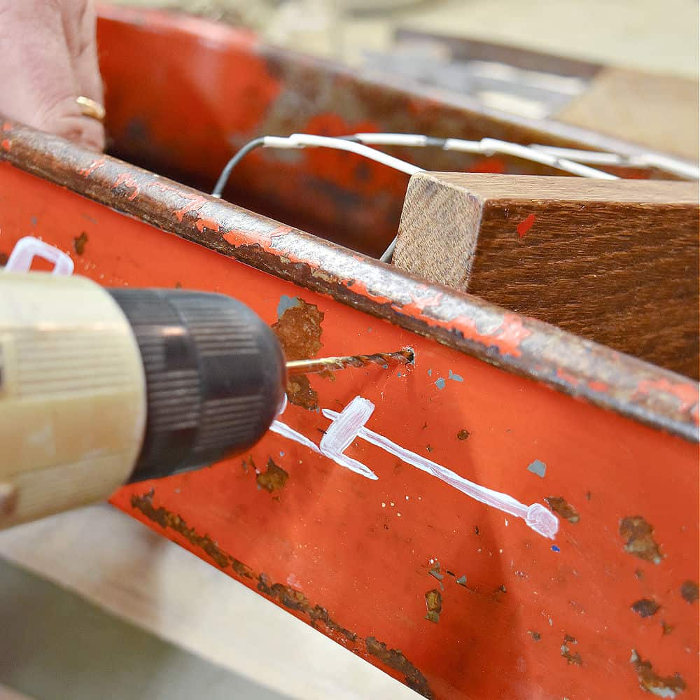 Drilling hole into vintage metal wagon.