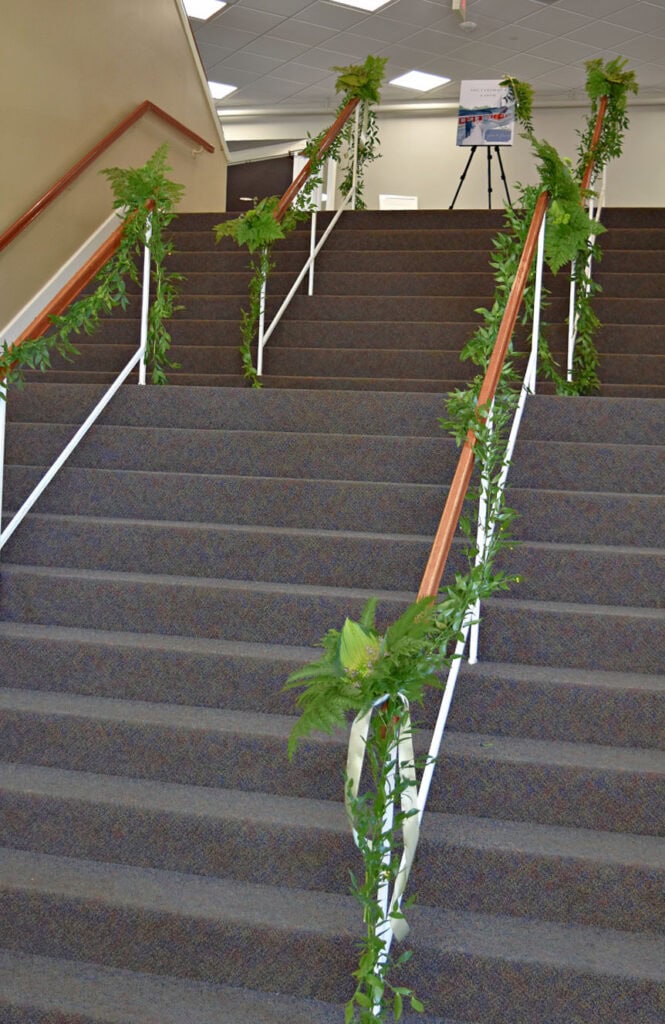 Green foliage garland on church stairway railing.