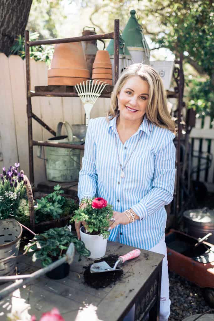 Woman planting potted plant.