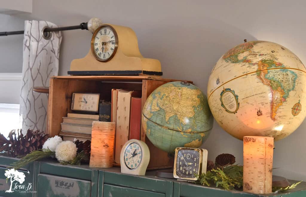 Vintage globes, clocks and books in a winter decorated living room