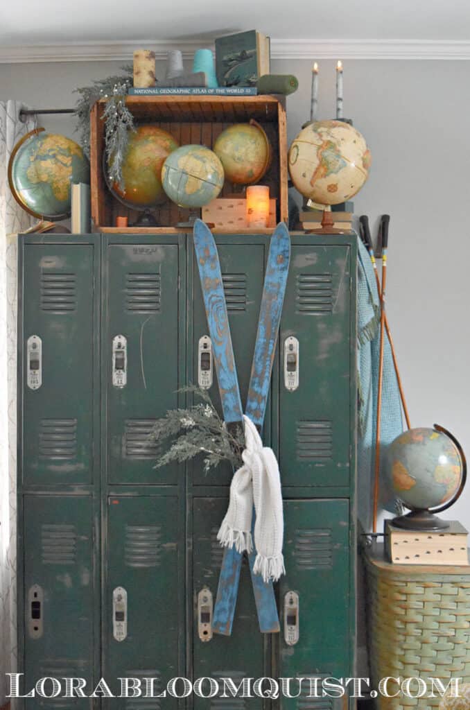 Vintage winter skis on old lockers with globe collection.