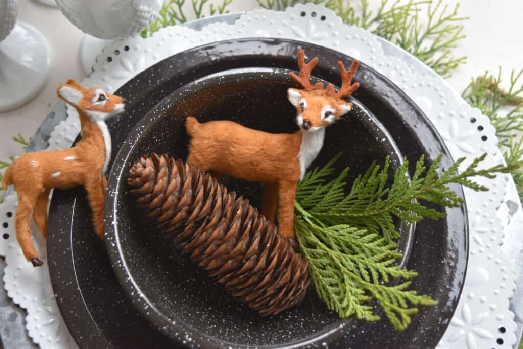 Mini deer figures on black and white plates.