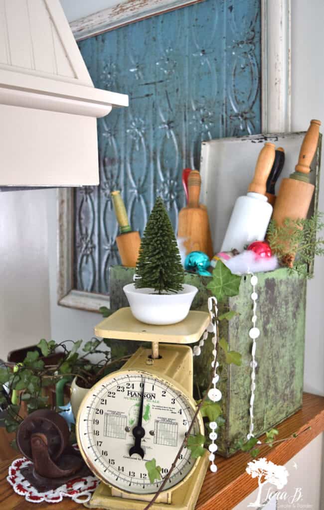 Vintage rolling pins and an antique scale decorate a Christmas kitchen