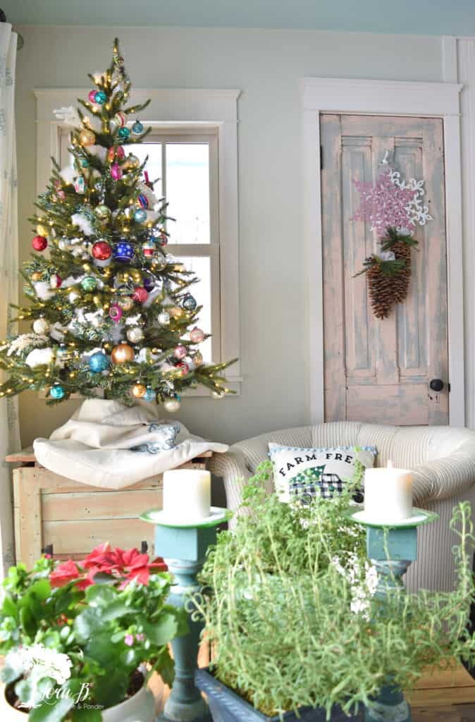 Vintage Shiny Brite ornaments fill a tree in a Christmas decorated kitchen