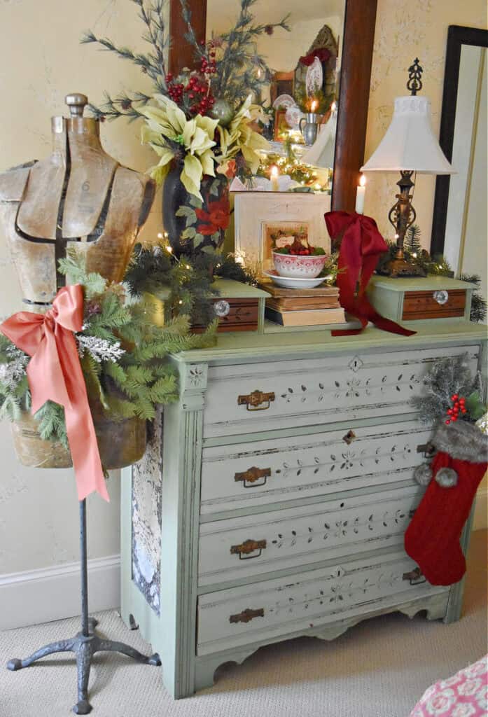 Vintage green painted dresser decorated in a Christmas bedroom.