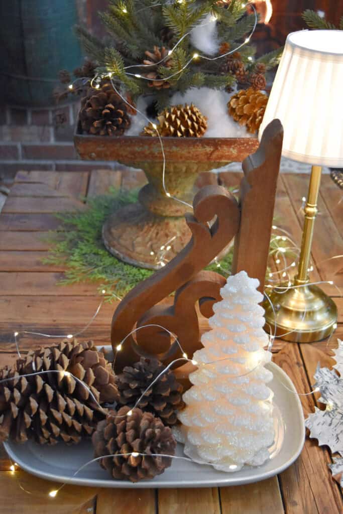 Pinecones and Christmas tree candle on coffee table.
