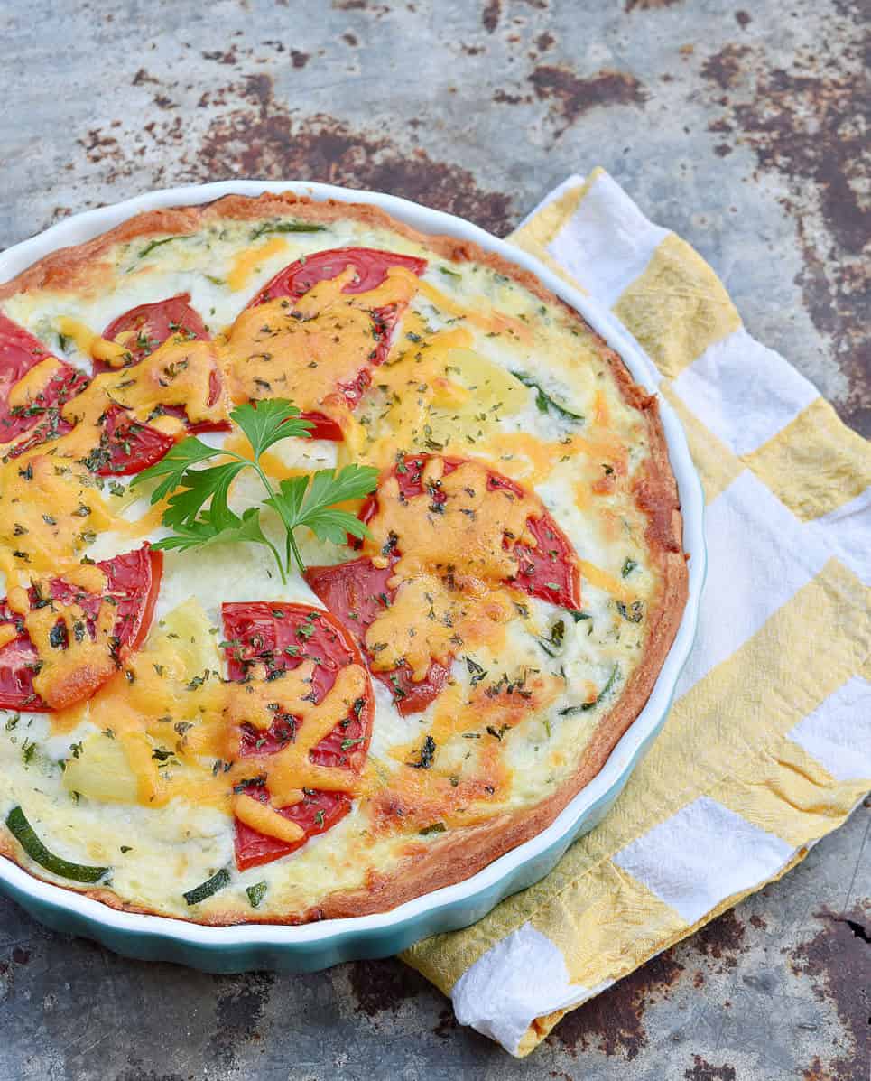 Zucchini quiche and yellow stripe napkin.